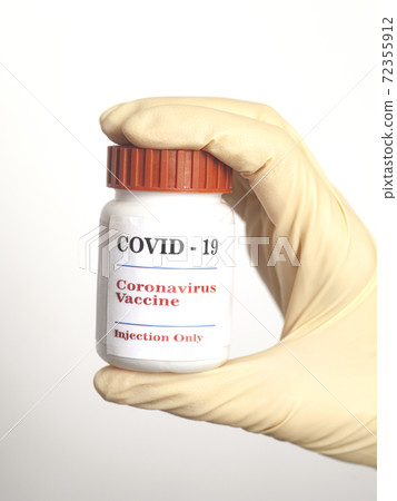 Vaccine Covid-19 Coronavirus glass bottle in medical doctor hand 72355912