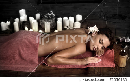 Massage woman back in beauty spa with candlelight Massage woman back in beauty spa with candlelight 72356183