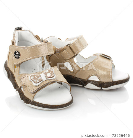Stylish beige baby sandals for girl on white background. Stylish beige baby sandals for girl on white background. 72356446