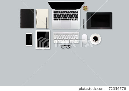 modern workspace table top view with laptop computer, coffee cup, office supplies and mobile on grey background 72356776