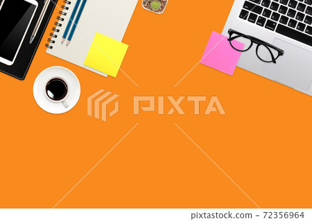 simple workspace technology orange table with laptop computer, coffee cup notebook and copy space 72356964