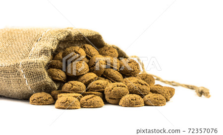 Traditional pepernoten treats in jute bag on white background 72357076