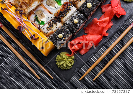 Japanese sushi food. Maki ands rolls with tuna, salmon, shrimp, crab and avocado. Top view of assorted sushi. 72357227