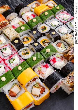 Set of sushi. Different types of Maki and Nigiri sushi. Bright and colorful service at the restaurant. Set of sushi. Different types of Maki and Nigiri sushi. Bright and colorful service at the restaurant. 72357228