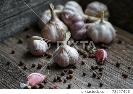 Garlic and peas peppers on wooden background. Ingredients for cooking. Garlic and peas peppers on wooden background. Ingredients for cooking. 72357408