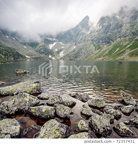 Hincovo pleso in the fog during sunrise. 72357431