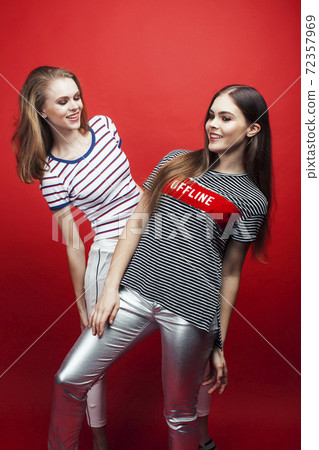 two best friends teenage girls together having fun, posing emotional on red background, lifestyle people concept two best friends teenage girls together having fun, posing emotional on red background, lifestyle people concept 72357969