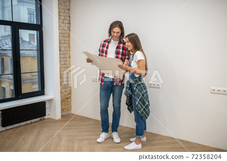 Young couple holding a design project and looking at it 72358204