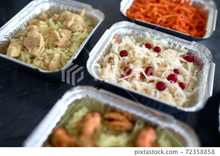 Different foil containers with delicious food. Different foil containers with delicious food. 72358858