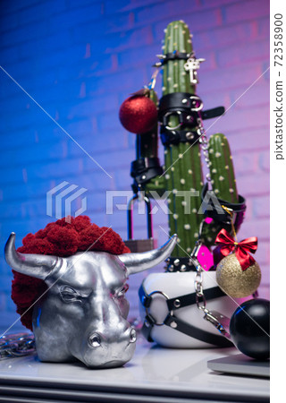 table with adult bdsm toys on a cactus and a metal bull symbol of the new year table with adult bdsm toys on a cactus and a metal bull symbol of the new year 72358900