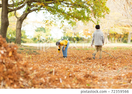 Children playing with fallen leaves Children playing with fallen leaves 72359566