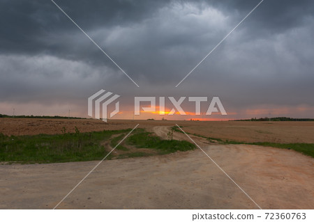 view of a plowed field at sunset 72360763