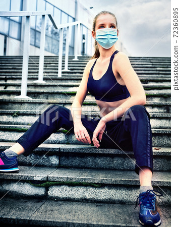 Running fitness sport in medical mask of woman. Coronavirus control Running fitness sport in medical mask of woman. Coronavirus control 72360895