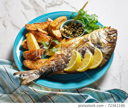 grilled fish with potato on a plate grilled fish with potato on a plate 72361186