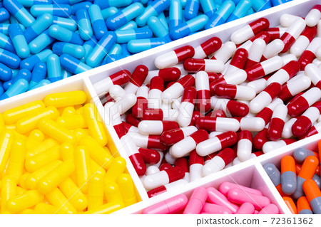 Top view of colorful capsule pills in plastic tray. Pharmaceutical industry. Healthcare and medicine. Pharmaceutics concept. Vitamins and supplements capsule. Full frame of bright color capsule pills. 72361362