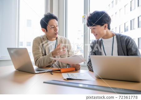 A young businessman brainstorming in a conference room A young businessman brainstorming in a conference room 72361778