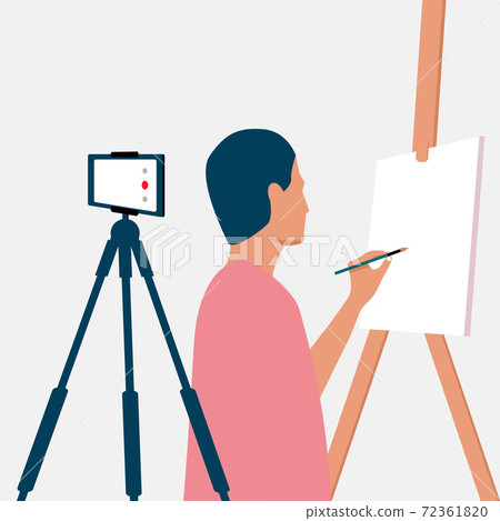 A man draws on an easel and records an online drawing lesson on her phone. Online courses, e-learning. Live translation on social networks. Home activity during quarantine. A man draws on an easel and records an online drawing lesson on her phone. Online courses, e-learning. Live translation on social networks. Home activity during quarantine. 72361820