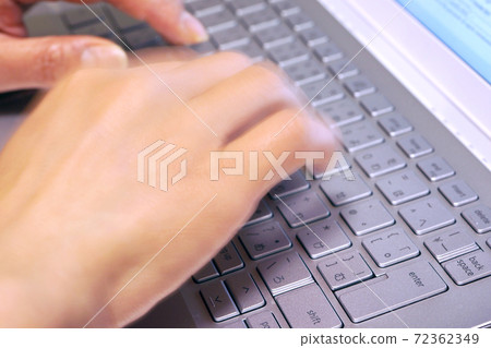 A woman typing a laptop A woman typing a laptop 72362349