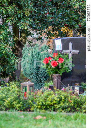 Facemask lying on grave of family members with a facemask during the pandemic 72362751