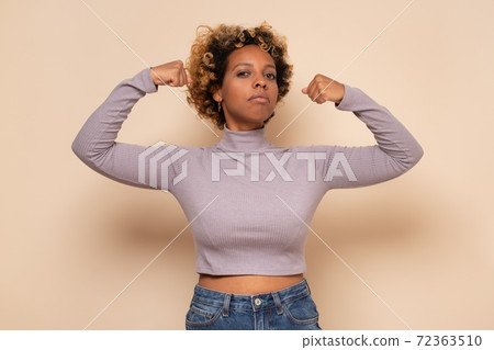 Strong young african woman in showing biceps, being strong. Strong young african woman in showing biceps, being strong. 72363510