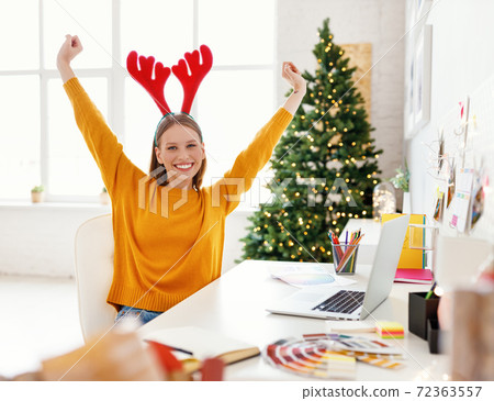 Cheerful freelancer finishing work on Christmas day. 72363557