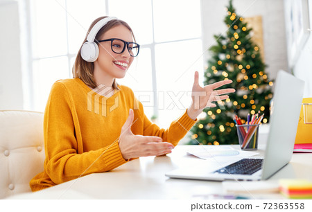 Happy employee making video call on Christmas day 72363558