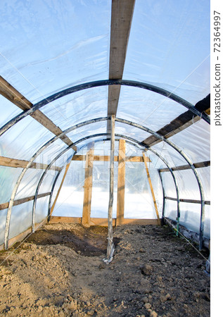 Homemade plastic arch empty  greenhouse in winter 72364997