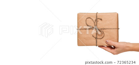 Hand woman holding gift box on white background. Long wide banner 72365234