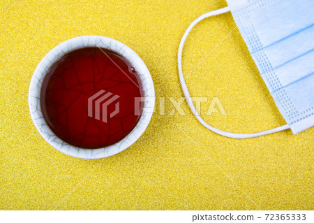 image of tea cup mask gold background  72365333