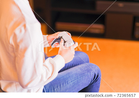 Teenager playing with a game controller [e-sports] 72365657