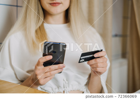 Shopping online, Savvy Shoppers, Installment Payments. Woman at home using credit card and laptop for online payment. Internet shopping concept Shopping online, Savvy Shoppers, Installment Payments. Woman at home using credit card and laptop for online payment. Internet shopping concept 72366069