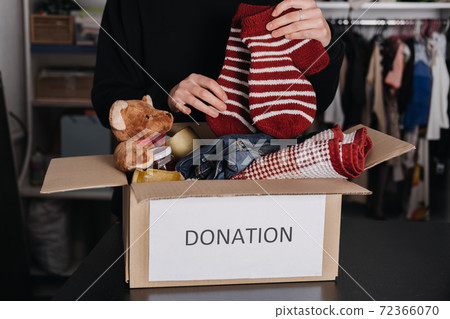 Donation box, Charity Gift hampers, Help Refugees and homeless. Christmas Xmas Charity Donation box with warm clothes, food and toys at home. Charities giving winter hampers to families in need Donation box, Charity Gift hampers, Help Refugees and homeless. Christmas Xmas Charity Donation box with warm clothes, food and toys at home. Charities giving winter hampers to families in need 72366070