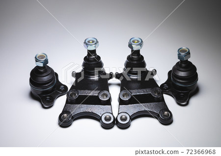 New set of spare parts for the front suspension of the SUV. 4 Ball joints in contrasting light on a black and white background New set of spare parts for the front suspension of the SUV. 4 Ball joints in contrasting light on a black and white background 72366968