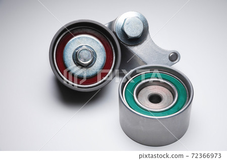 Two tensioning rollers of the engine timing belt on a gray background. New spare parts for car engine repair 72366973