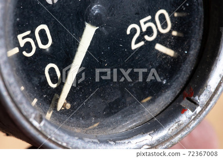 Close-up of an old industrial pressure gauge display with worn protective glass. Macro 72367008