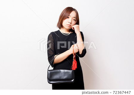 A woman in mourning clothes who has troubles A woman in mourning clothes who has troubles 72367447