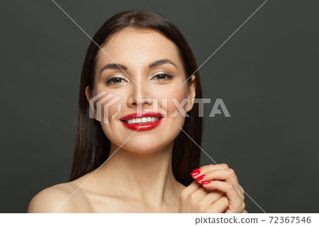 Pretty model woman brunette with makeup and red manicured nails on black background Pretty model woman brunette with makeup and red manicured nails on black background 72367546