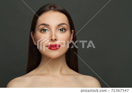 Beautiful healthy brunette woman smiling on black background portrait 72367547