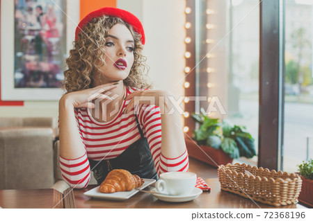 Romantic young woman in european cafee 72368196