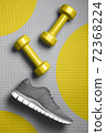 Yellow color dumbbells and gray color sneakers on the mat 72368224