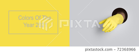 Yellow glove in grey hole background. Yellow glove in grey hole background. 72368966