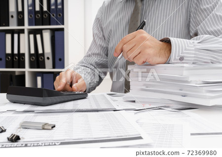 business concept - businessman's working table close view, checks financial reports, writes and counts business concept - businessman's working table close view, checks financial reports, writes and counts 72369980