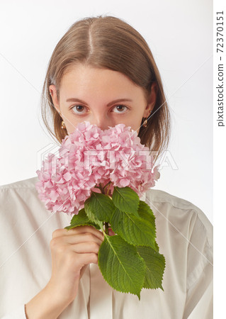 woman smells flower 72370151