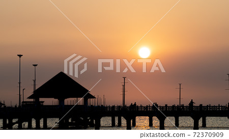 Bangsan Chonburi Thailand jetty and sunset. At Bangsan beach. Ao Thai Ocean. Beautiful sunset landscape, wooden shore jetty and colorful sky and cloud. Artistic beach sunset under wonderful sky. Recre Bangsan Chonburi Thailand jetty and sunset. At Bangsan beach. Ao Thai Ocean. Beautiful sunset landscape, wooden shore jetty and colorful sky and cloud. Artistic beach sunset under wonderful sky. Recre 72370909