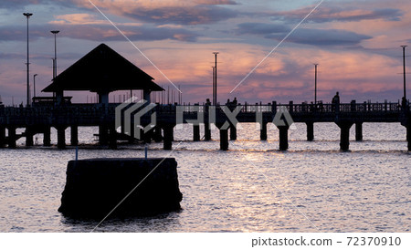 Bangsan Chonburi Thailand jetty and sunset. At Bangsan beach. Ao Thai Ocean. Beautiful sunset landscape, wooden shore jetty and colorful sky and cloud. Artistic beach sunset under wonderful sky. Recre 72370910