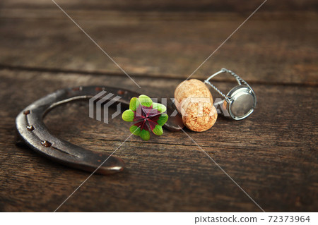 Horseshoe with lucky clover on a wooden background Horseshoe with lucky clover on a wooden background 72373964