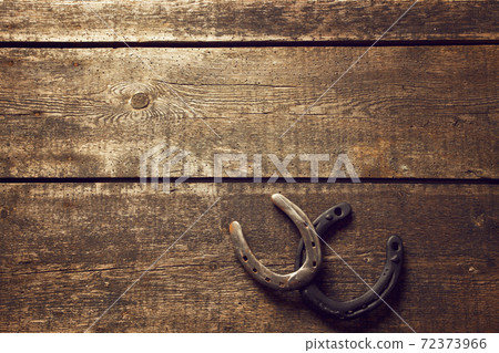 Horseshoe with lucky clover on a wooden background Horseshoe with lucky clover on a wooden background 72373966