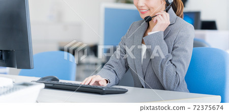 Young business woman working in a call center Young business woman working in a call center 72375674