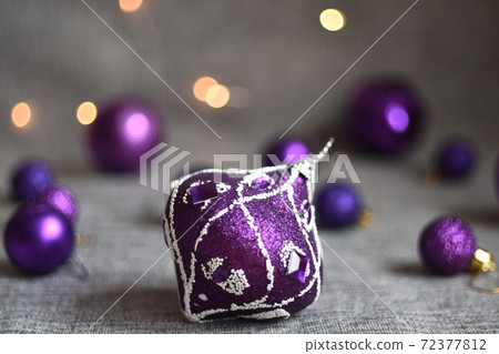 christmas toys balls magenta on gray fabric background 72377812