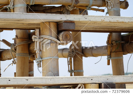 Close up rope tied with bamboo to make a stand for the building construction work. Close up rope tied with bamboo to make a stand for the building construction work. 72379606